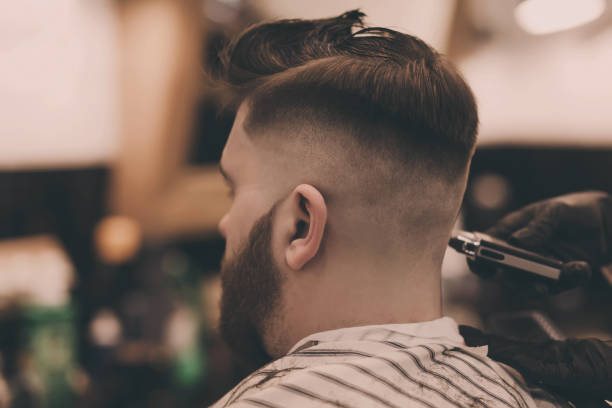 istock professional hairdresser cuts a man's 1209243744