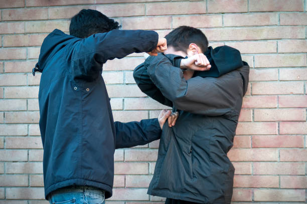 istock Bullying, aggression and violence scene between two young adult males 1209246670