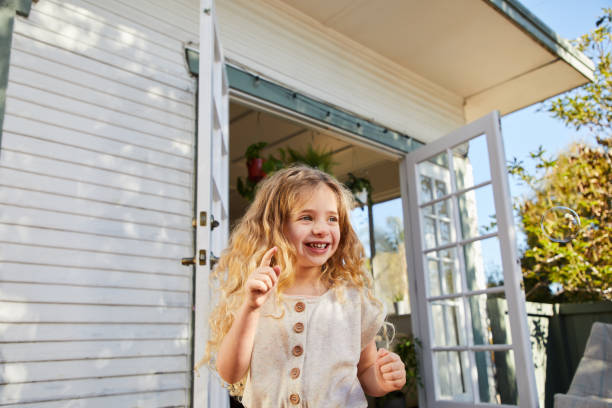 istock Cute little girl smiling and playing with bubbles outside 1209249426
