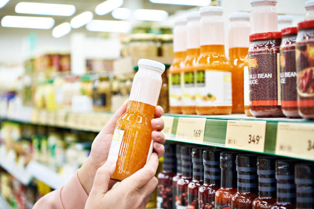 istock Culinary sauce in hand buyer at store 1209250548