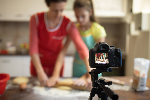 istock Mother and daughter preparing bakery and recording process 1209255720
