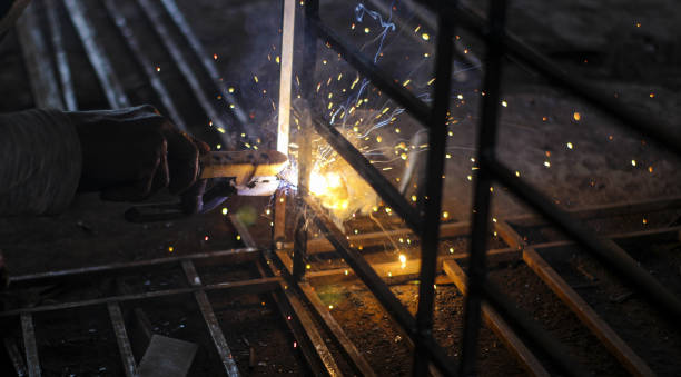 istock Welder Technician Are Welding Steel With Sparks Flying.Selective focus with copy space for text. 1209257345
