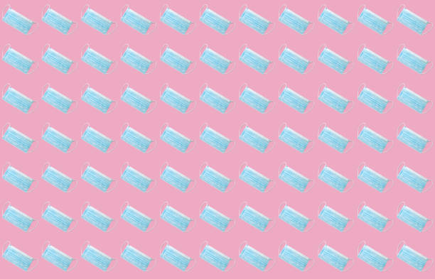 istock Medical mask pattern on pink background. Protective face mask background. 1209258471
