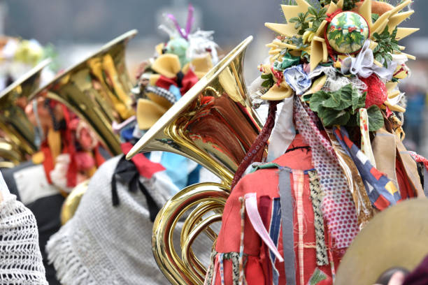 Lucerne, Switzerland - February 20, 2023: Band of musicians in costumes march in the streets, and crowd, part of the Fasnacht Carnival, in Lucerne (Luzern), Switzerland