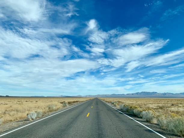istock Desert highway. A long, straight road through a remote location. 1209260072