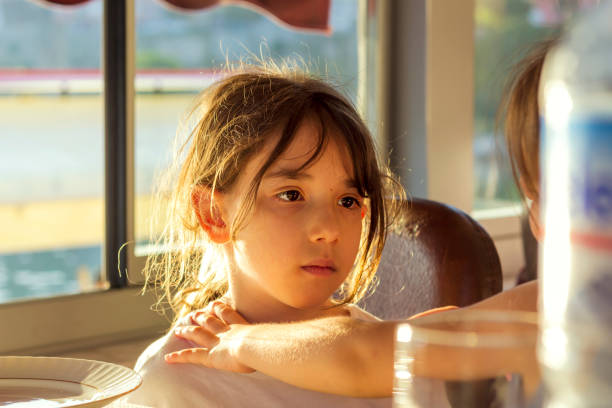 A hungry little girl enjoys eating BBQ ribs.Select the image below for similar images: