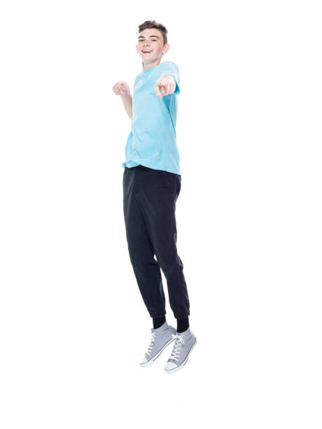 istock Caucasian boys jumping in front of white background 1209263539