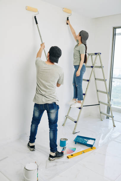 istock Couple painting walls 1209264025