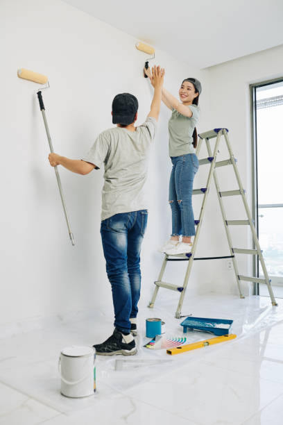 istock Couple finishing painting 1209264028