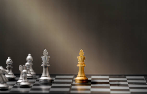 istock golden and silver chess pieces on dark background 1209264034