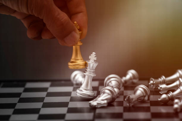istock golden and silver chess on chess board, business concept 1209264071