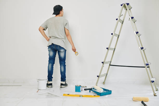 istock College student painting walls 1209264106