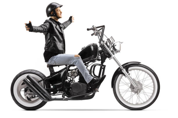 istock Young biker riding a custom chopper motorbike without hands 1209265194