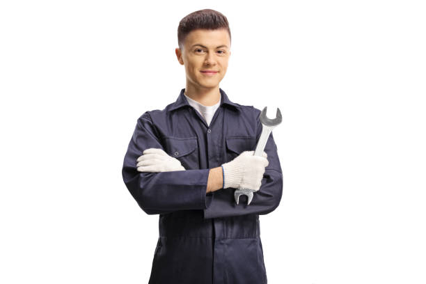 istock Young auto mechanic holding a wrench and looking at the camera 1209265215