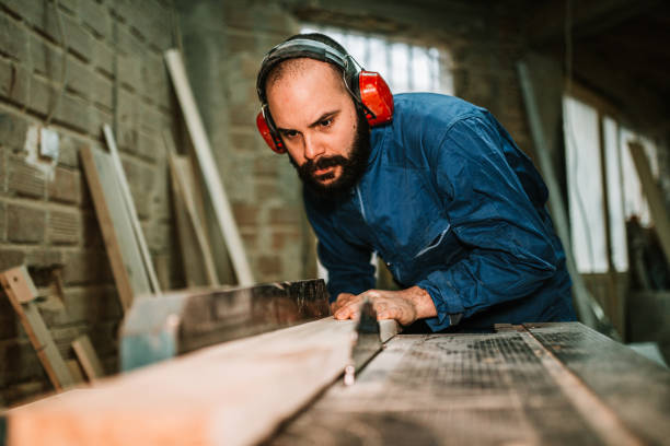 istock Carpenter working in the workshop cutting wood 1209265450