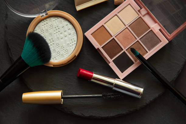 istock Set of decorative cosmetics, makeup tools and accessories on black slate background. Copy space. Flat lay. Top view. Skin care or morning routine concept 1209265925
