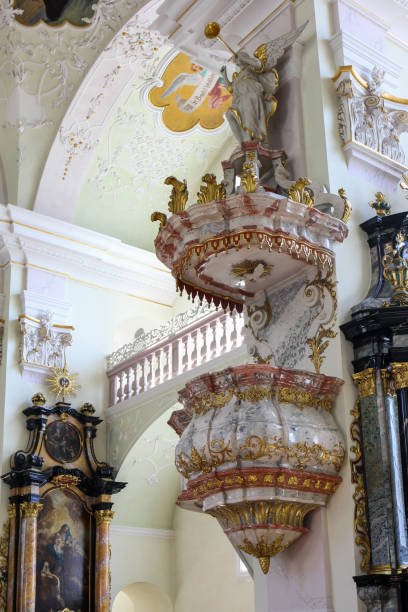 Engelberg, Switzerland - April 09.2017: The rococo style pulpit made of colorful marble in the Benedictine Kloster, Engelberg, Switzerland