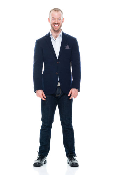 caucasian male manager standing in front of white background wearing jeans - arms at side imagens e fotografias de stock