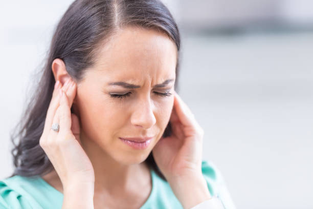 young woman have headache migraine stress or tinnitus - noise whistling in her ears. - have imagens e fotografias de stock