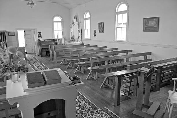 Pews in a church or possible benches in an auditorium.
