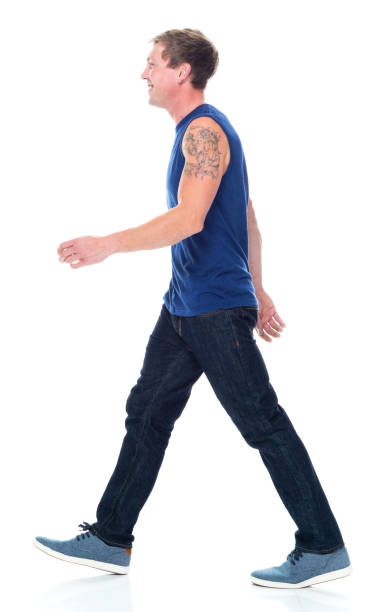 caucasian young male sleeveless walking in front of white background wearing canvas shoe - 16727 imagens e fotografias de stock