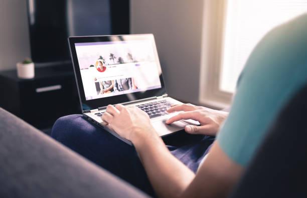 Social media profile on screen. Man using laptop at home. Personal online page. Business network website mockup. Writing status update.