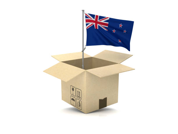Engineer is holding yellow safety helmet with waving Cayman Islands flag background. Construction and building concept.