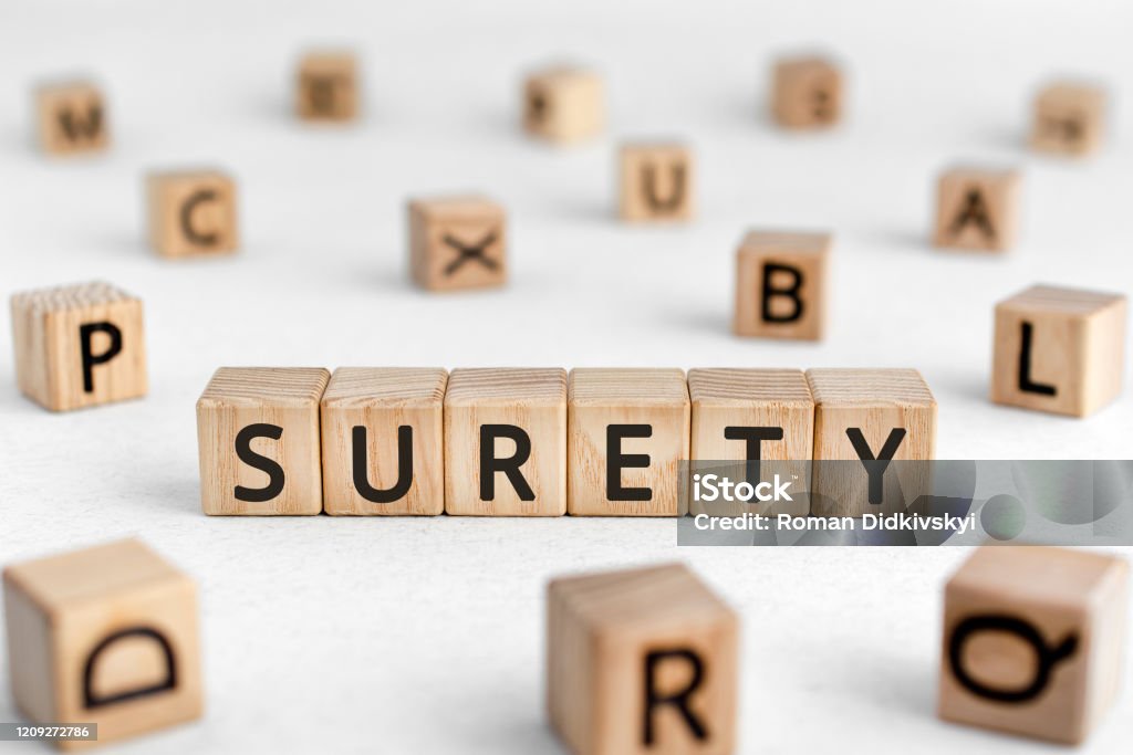 Surety - words from wooden blocks with letters Surety - words from wooden blocks with letters, a person who takes responsibility for another's surety concept, white background Bonding Stock Photo