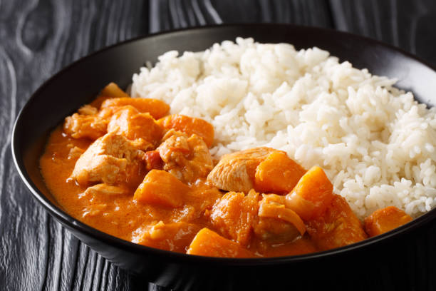 domoda, a delicious peanut stew, is the national dish of gambia. the rich and delicious vegetable and meat stew is served over rice close-up in a plate. horizontal - portion pumpkin vegetable black imagens e fotografias de stock