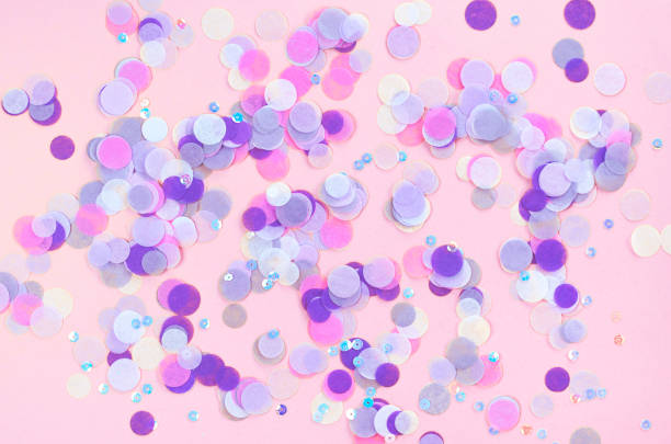 istock Festive pink background with violet confetti. 1209275009