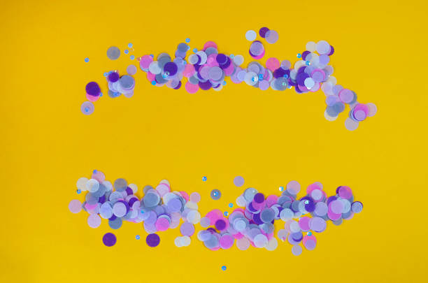 istock Festive orange background with violet confetti. 1209275035
