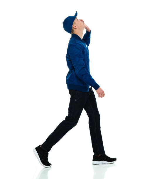istock Caucasian boys walking in front of white background wearing baseball cap 1209276139