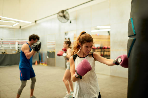 istock Caucasian woman practicing and exercising with a punching bag. 1209276915