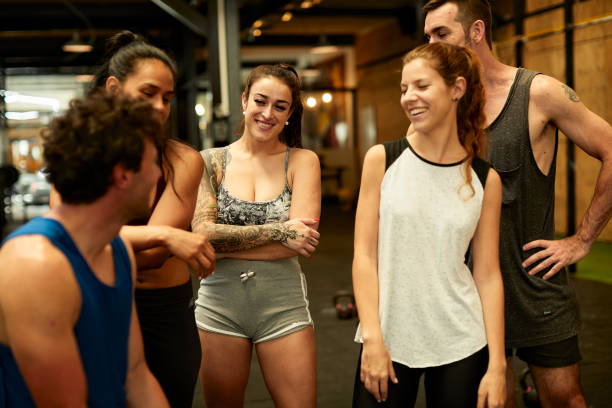 istock Group of friends standing and talking in a cross training gym. 1209276921
