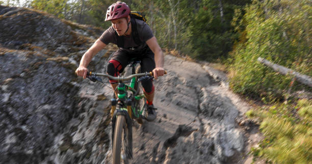istock Mountain biker descends steep rock slab 1209276980