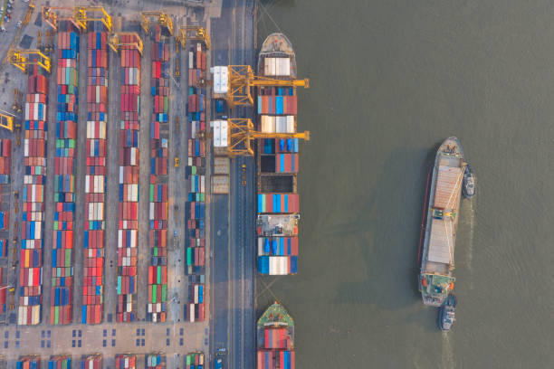istock Container ship in export and import business and logistics. Shipping cargo to harbor by crane. Water transport International. Aerial view and top view. 1209277353