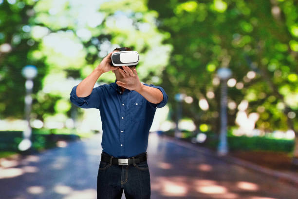 istock Caucasian male standing in front of public park and using augmented reality 1209278763