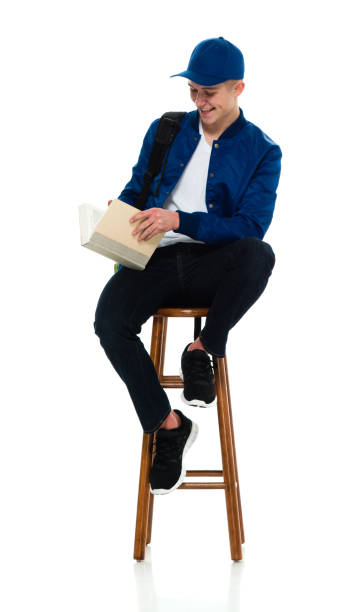 istock Teenage boys university student resting wearing backpack and holding book 1209278898