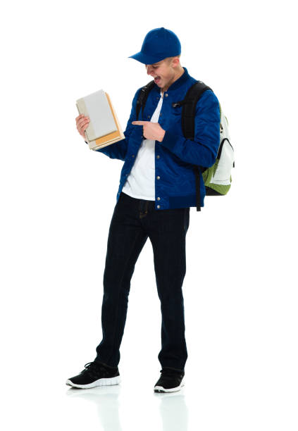 istock Boys high school student standing wearing backpack and holding textbook 1209279773