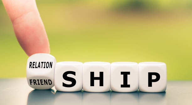 istock Friendship or relationship? Hand turns dice and changes the word 