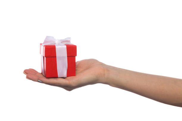 istock female hand holds a beautiful gift box with a bow isolated on white background 1209286220