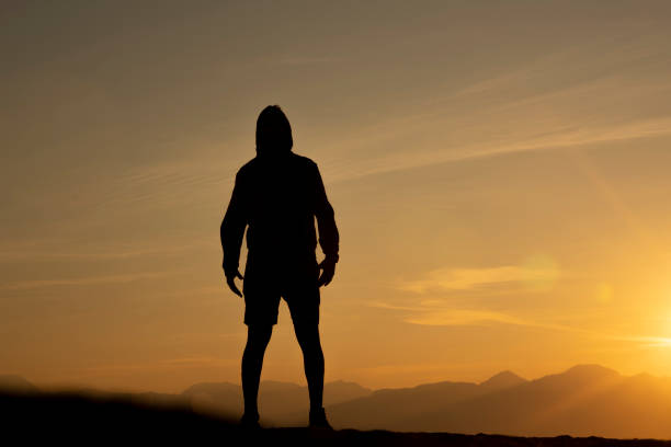istock silhouette of an athlete man at sunrise 1209286606