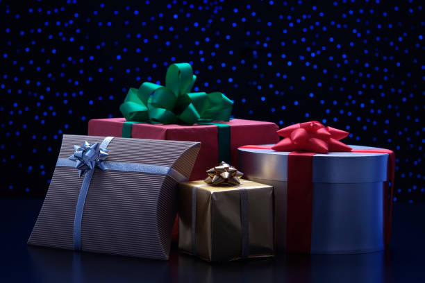 istock Four elegant gift boxes with ribbon against blue illumination background 120928745