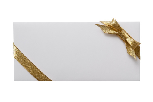 White envelope with decoration gold bow isolated on white background with CLIPPING PATH.