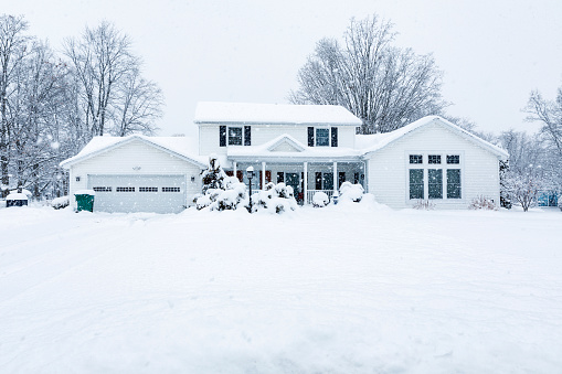 Suburban Colonial Home During Extreme Blizzard Snow Storm