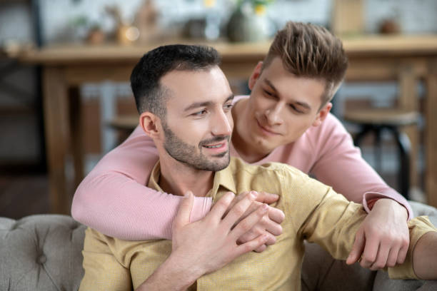 istock Young fair-haired man putting hand on his partners shoulder 1209289672