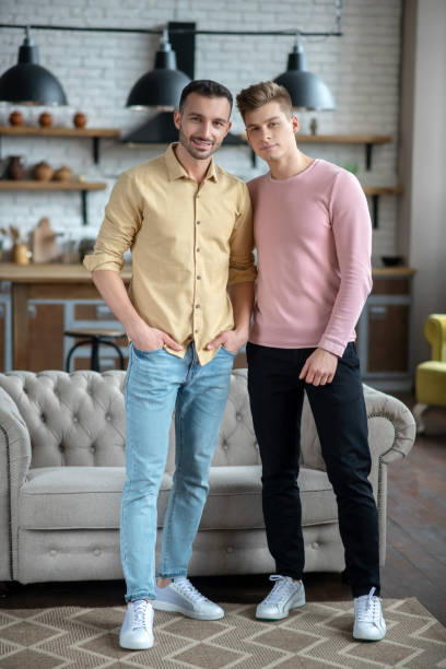istock Two young men standing smiling happily and looking good 1209289704