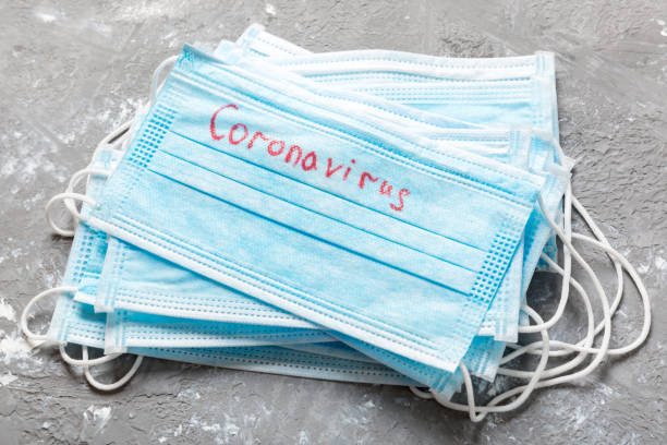 istock coronavirus word written on medical mask. Coronavirus text on protective mask for your desing, Wuhan , 2019-nCoV. concept top view 1209290535