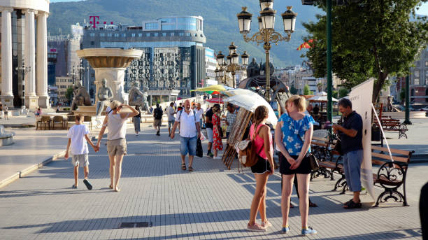 people on main square, modern architecture and historic buildings of skopje capital city of north macedonia on sunny summer day - europe bridge editorial eastern europe imagens e fotografias de stock