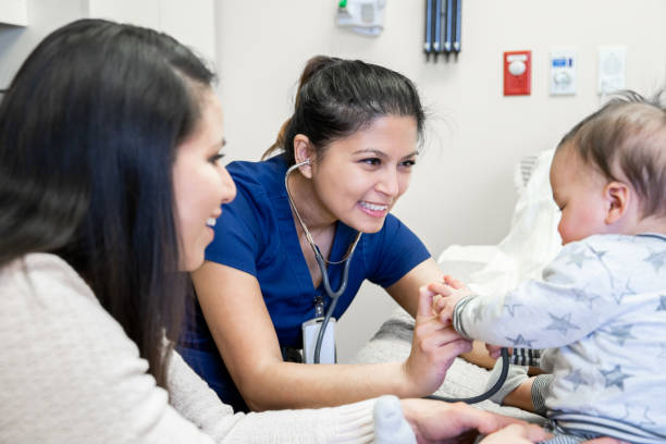 istock Nurse listens to baby with stethoscope at check up 1209299351